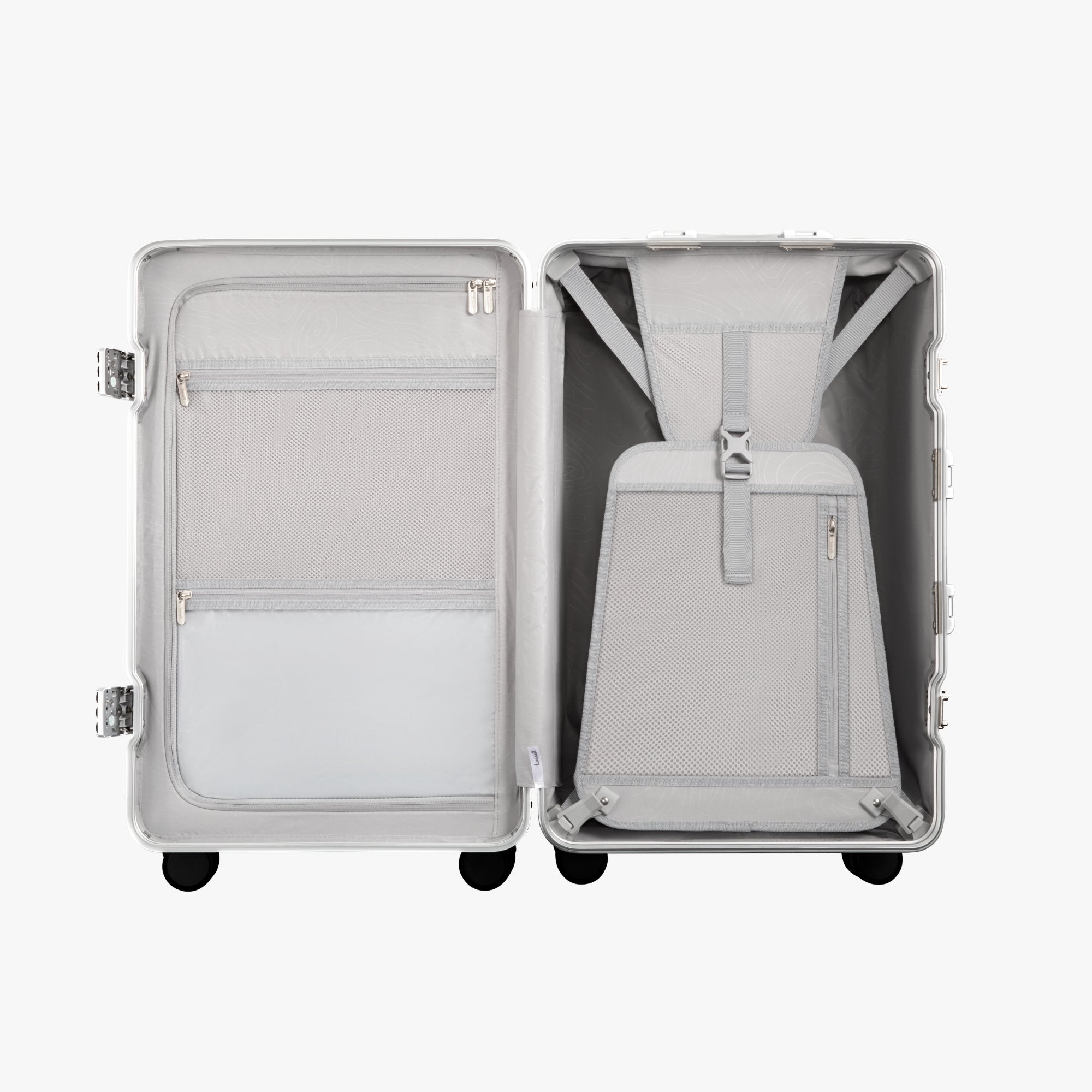Open view of the LUGGEX 24-inch silver aluminum-frame zipperless check-in suitcase showing upgraded interior with greater flexibility, smarter organization, and a waterproof pocket.