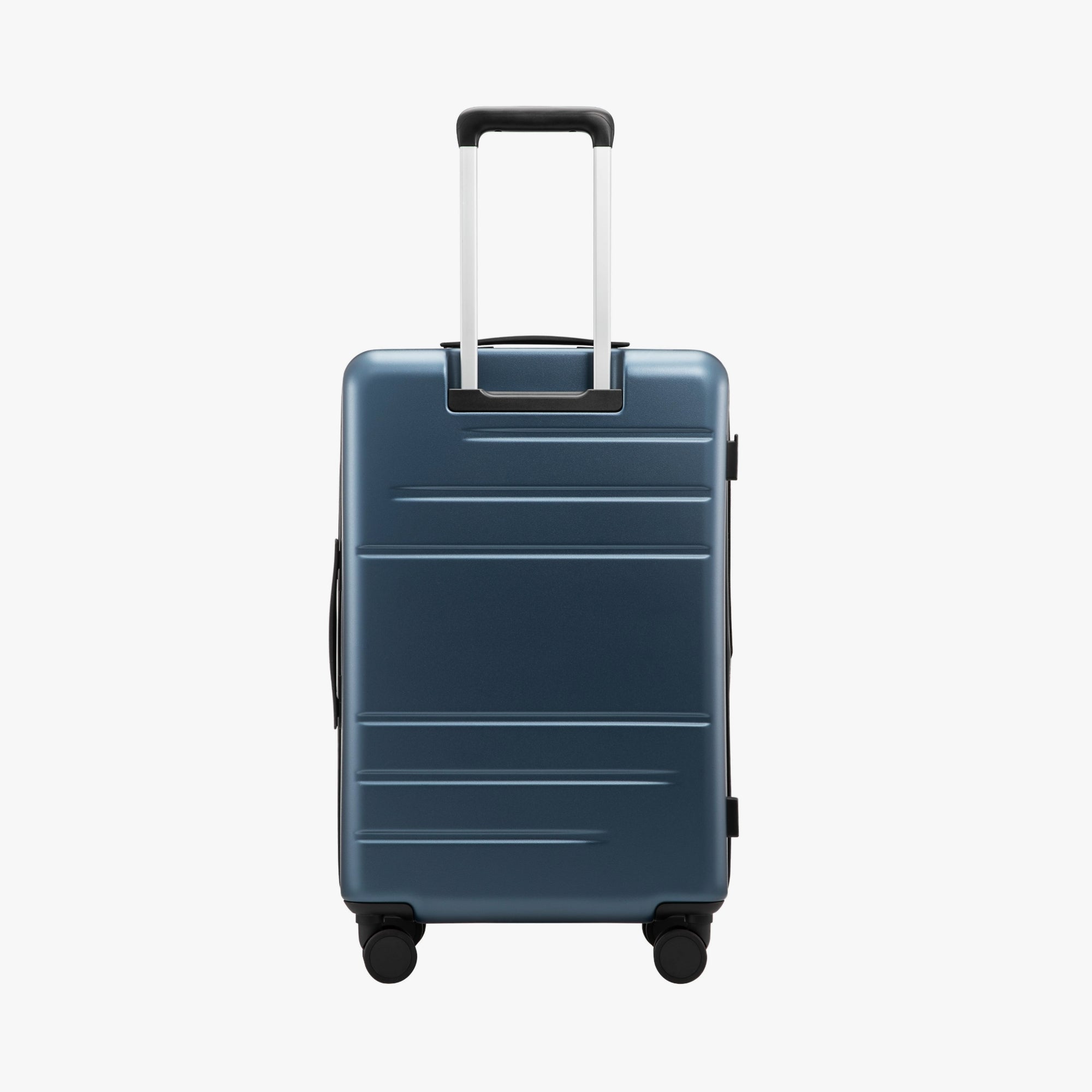 Back view of LUGGEX FLO 5 24-inch charcoal zipper suitcase made from 100% polycarbonate, featuring a telescopic handle and side footrest that doubles as a hanging hook for bags or small items.