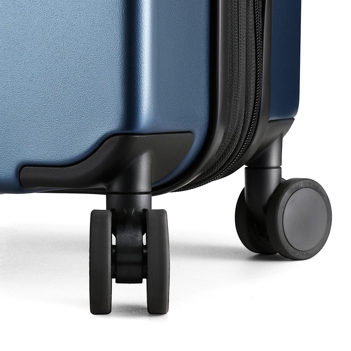 Close-up of 360-degree quiet spinner wheels on LUGGEX FLO 5 Core carry-on suitcase for smooth, silent travel.