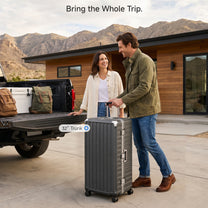 Two LUGGEX 32-inch black zipperless aluminum frame trunk luggage pieces loaded in a pickup truck bed, with a warning that 32-inch size may exceed some airline size limits.#color_charcoal #show