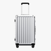 Side view of 24'' aluminum frame trunk luggage with a 4:6 trunk structure and protective foot pads that prevent scratches and wear when placed on the ground.  