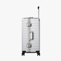 Side view of 24'' aluminum frame trunk luggage with a 4:6 trunk structure and protective foot pads that prevent scratches and wear when placed on the ground.  