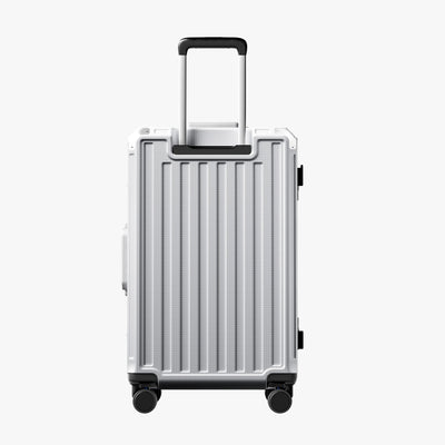 Side view of 24'' aluminum frame trunk luggage with a 4:6 trunk structure and protective foot pads that prevent scratches and wear when placed on the ground.  
