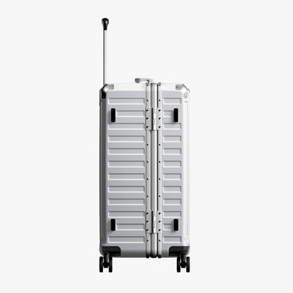 Side view of 24'' aluminum frame trunk luggage with a 4:6 trunk structure and protective foot pads that prevent scratches and wear when placed on the ground.  