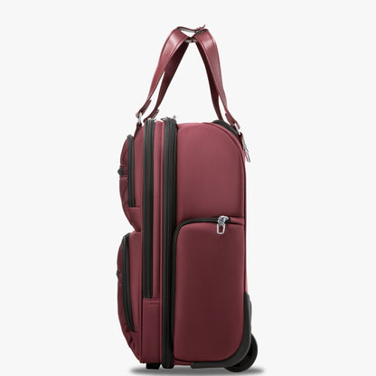 Side view of 16-inch underseat carry-on luggage with wheels, showing a slim profile, smooth-rolling wheels, and multiple zippered side pockets. #show #color_cherry_red
