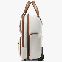 Side view of 16-inch underseat carry-on luggage with wheels, showing a slim profile, smooth-rolling wheels, and multiple zippered side pockets. #show #color_cream-white