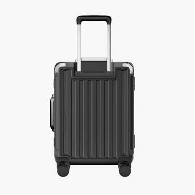 Side view of aluminum frame luggage with protective foot pads that elevate the shell and prevent scratches when the suitcase is placed on the ground. #show #color_charcoal