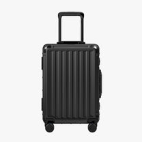 Side view of aluminum frame luggage with protective foot pads that elevate the shell and prevent scratches when the suitcase is placed on the ground. #show #color_black
