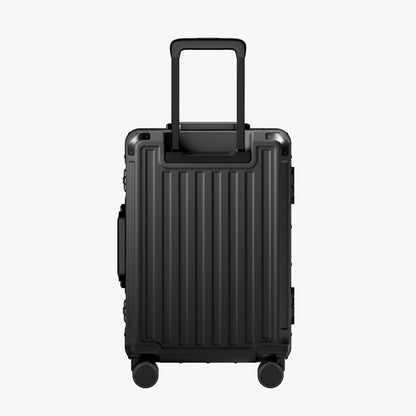 Side view of aluminum frame luggage with protective foot pads that elevate the shell and prevent scratches when the suitcase is placed on the ground. #show #color_black