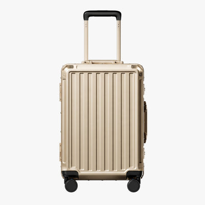 Side view of aluminum frame luggage with protective foot pads that elevate the shell and prevent scratches when the suitcase is placed on the ground. #show #color_champagne_gold