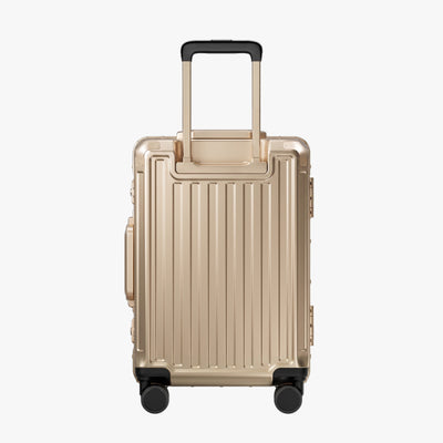 Side view of aluminum frame luggage with protective foot pads that elevate the shell and prevent scratches when the suitcase is placed on the ground. #show #color_champagne_gold