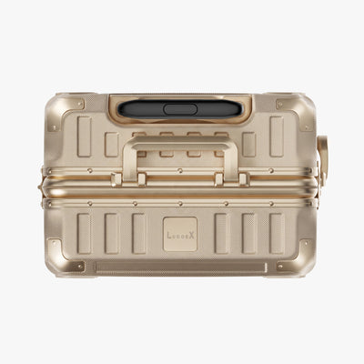Side view of aluminum frame luggage with protective foot pads that elevate the shell and prevent scratches when the suitcase is placed on the ground. #show #color_champagne_gold