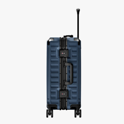 Side view of aluminum frame luggage with protective foot pads that elevate the shell and prevent scratches when the suitcase is placed on the ground. #show #color_navy_blue