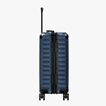 Side view of aluminum frame luggage with protective foot pads that elevate the shell and prevent scratches when the suitcase is placed on the ground. #show #color_navy_blue