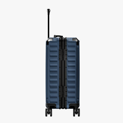 Side view of aluminum frame luggage with protective foot pads that elevate the shell and prevent scratches when the suitcase is placed on the ground. #show #color_navy_blue
