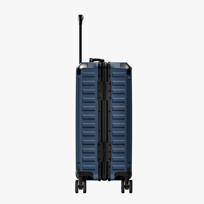 Side view of aluminum frame luggage with protective foot pads that elevate the shell and prevent scratches when the suitcase is placed on the ground. #show #color_navy_blue