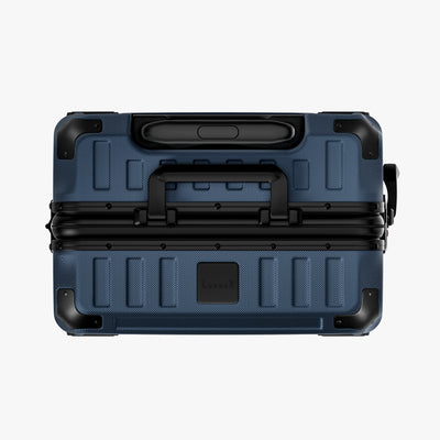 Side view of aluminum frame luggage with protective foot pads that elevate the shell and prevent scratches when the suitcase is placed on the ground. #show #color_navy_blue