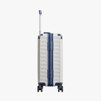 Side view of aluminum frame luggage with protective foot pads that elevate the shell and prevent scratches when the suitcase is placed on the ground. #show #color_white_blue