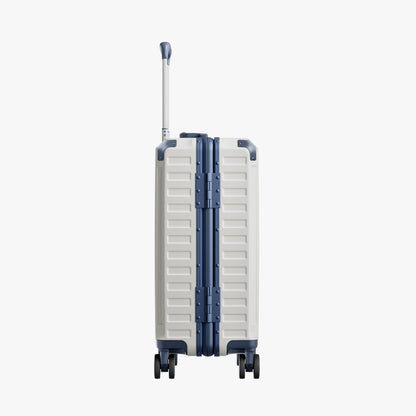 Side view of aluminum frame luggage with protective foot pads that elevate the shell and prevent scratches when the suitcase is placed on the ground. #show #color_white_blue