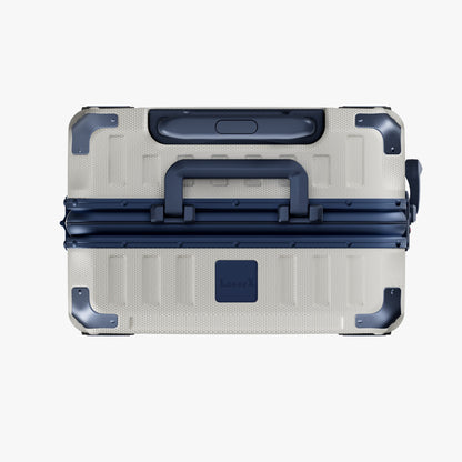 Side view of aluminum frame luggage with protective foot pads that elevate the shell and prevent scratches when the suitcase is placed on the ground. #show #color_white_blue