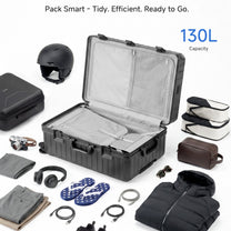 LUGGEX 32-inch black trunk luggage open with 130L capacity, surrounded by travel essentials including ski helmet, headphones, camera, packing cubes, toiletry bag, flip flops, jacket, pants, and cables.#color_charcoal #show