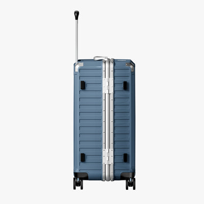 LUGGEX Side view of an aluminum frame trunk luggage with a 4:6 trunk structure and protective foot pads that prevent scratches and wear when placed on the ground.  