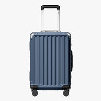 Side view of aluminum frame luggage with protective foot pads that elevate the shell and prevent scratches when the suitcase is placed on the ground. #show #color_blue