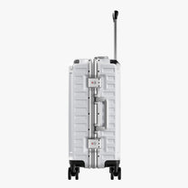 Side view of aluminum frame luggage with protective foot pads that elevate the shell and prevent scratches when the suitcase is placed on the ground. #show #color_sliver_grey
