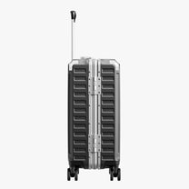 Side view of aluminum frame luggage with protective foot pads that elevate the shell and prevent scratches when the suitcase is placed on the ground. #show #color_charcoal