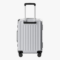 Side view of aluminum frame luggage with protective foot pads that elevate the shell and prevent scratches when the suitcase is placed on the ground. #show #color_sliver_grey