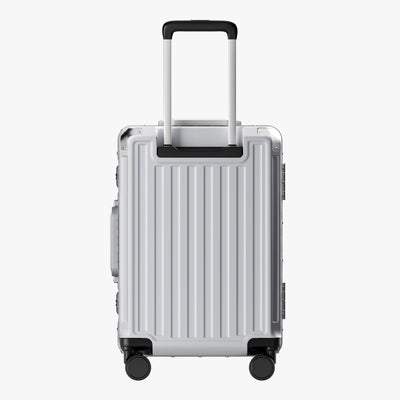 Side view of aluminum frame luggage with protective foot pads that elevate the shell and prevent scratches when the suitcase is placed on the ground. #show #color_sliver_grey