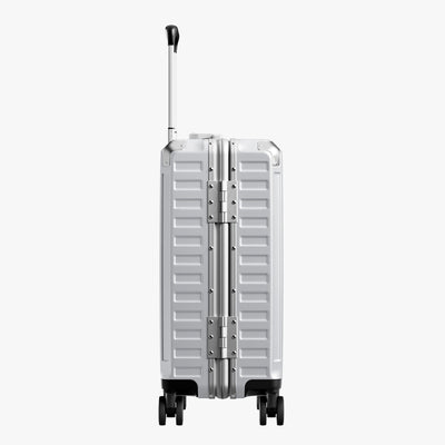 Side view of aluminum frame luggage with protective foot pads that elevate the shell and prevent scratches when the suitcase is placed on the ground. #show #color_sliver_grey