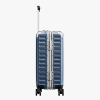 Side view of aluminum frame luggage with protective foot pads that elevate the shell and prevent scratches when the suitcase is placed on the ground. #show #color_blue
