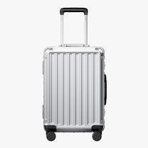 Side view of aluminum frame luggage with protective foot pads that elevate the shell and prevent scratches when the suitcase is placed on the ground. #show #color_sliver_grey