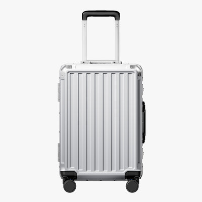 Side view of aluminum frame luggage with protective foot pads that elevate the shell and prevent scratches when the suitcase is placed on the ground. #show #color_sliver_grey