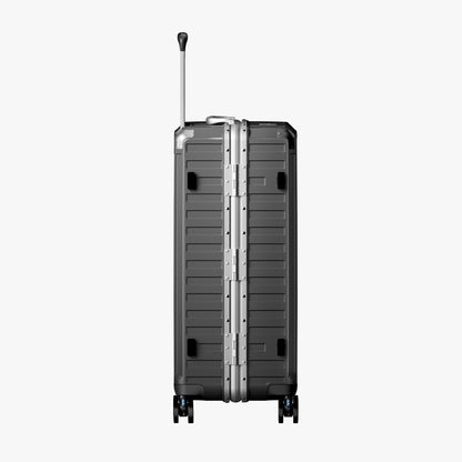 Side view of aluminum frame luggage with protective foot pads that elevate the shell and prevent scratches when the suitcase is placed on the ground. 