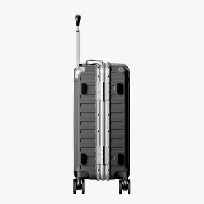 Side view of aluminum frame luggage with protective foot pads that elevate the shell and prevent scratches when the suitcase is placed on the ground. #show #color_charcoal