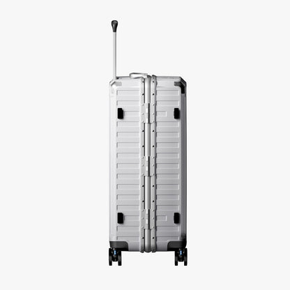 Side view of aluminum frame luggage with protective foot pads that elevate the shell and prevent scratches when the suitcase is placed on the ground. 