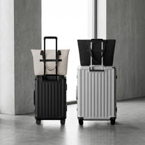 LUGGEX 15.6” laptop tote bags mounted on carry-on suitcases with integrated luggage sleeves for travel.

