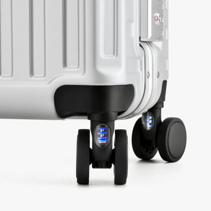 Close-up of LUGGEX 20-inch suitcase silent spinner wheels with shock-absorbing blue springs 