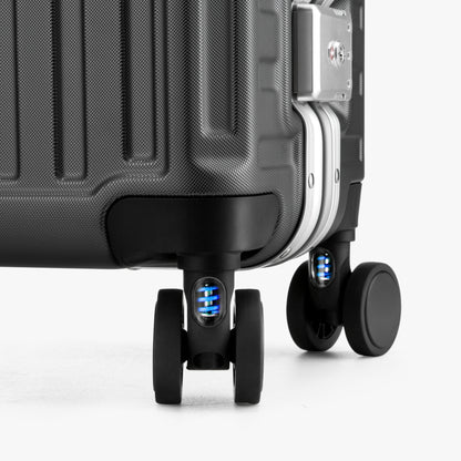 Close-up of LUGGEX 20-inch suitcase silent spinner wheels with shock-absorbing blue springs 
#color-charcoal