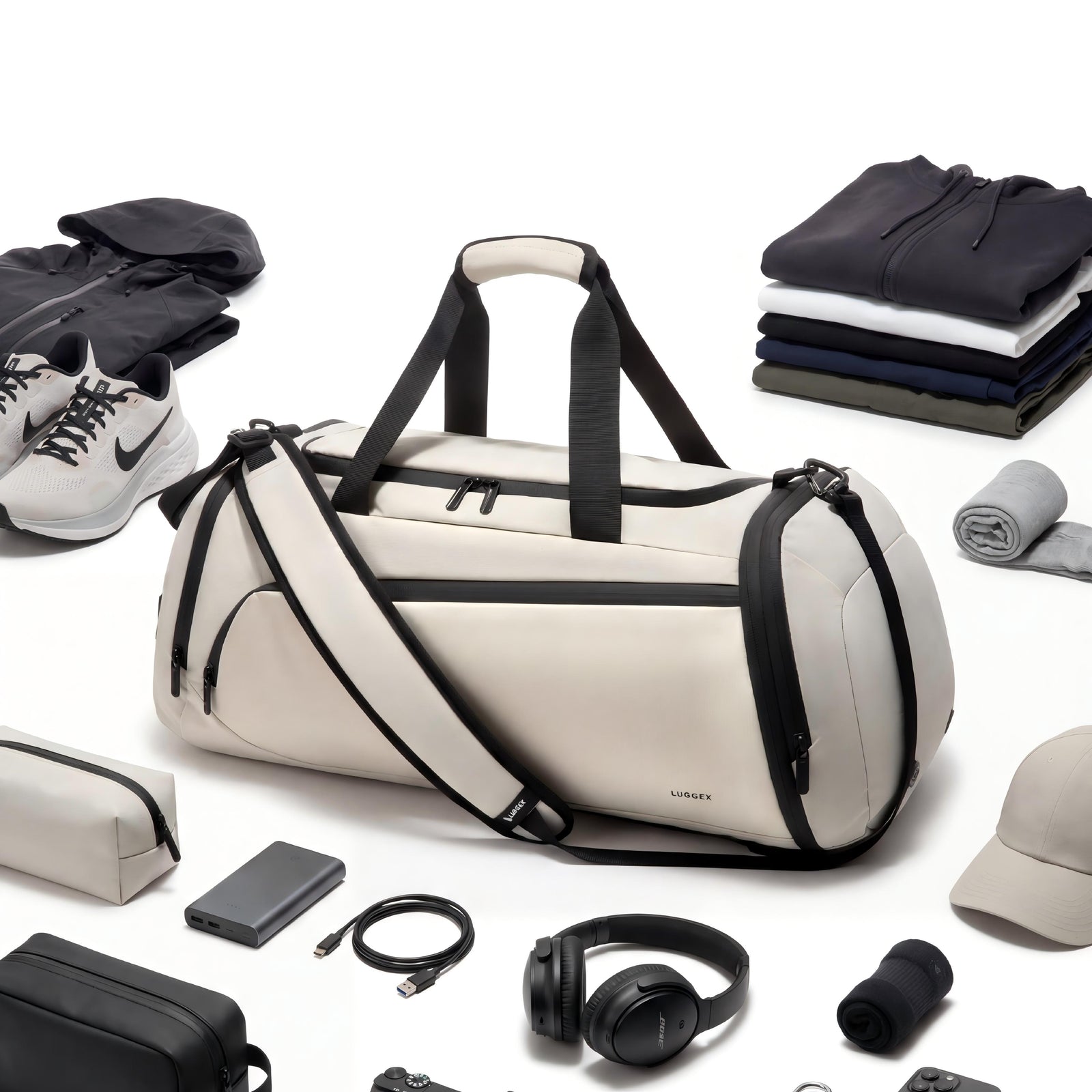 LUGGEX 40L expandable gym and travel duffel bag displayed with shoes, clothing and essentials to show packing capacity. 