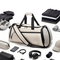 LUGGEX 40L expandable gym and travel duffel bag displayed with shoes, clothing and essentials to show packing capacity. 