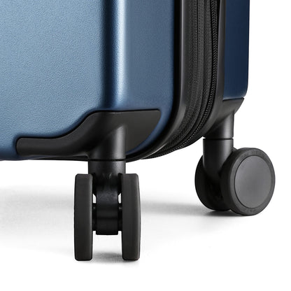 Close-up of 360-degree quiet spinner wheels on LUGGEX FLO 5 Core carry-on suitcase for smooth, silent travel. 