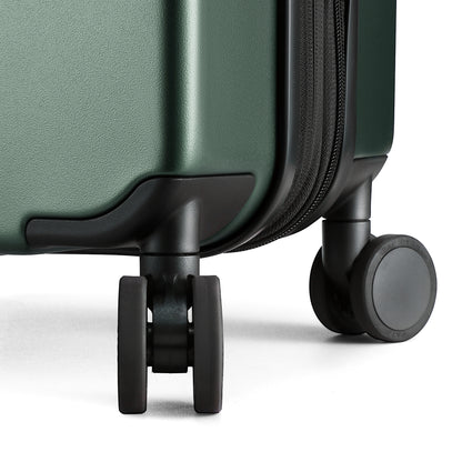 Close-up of 360-degree quiet spinner wheels on Luggex FLO 5 Core carry-on suitcase for smooth, silent travel. 