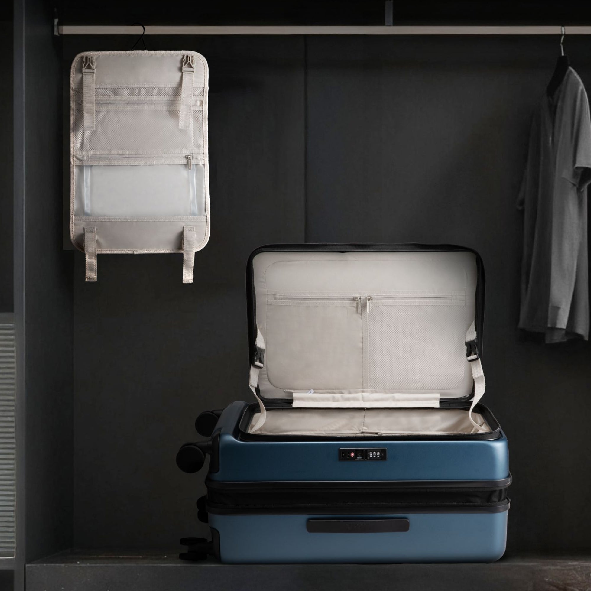 LUGGEX FLO 5 suitcase with removable interior divider hanging in closet, showing detachable organizer and spacious suitcase compartment 
